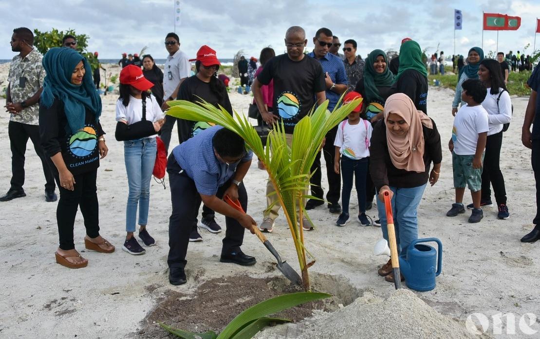 Planting a sapling at a community event